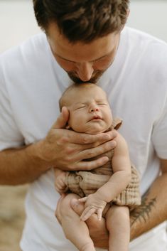 a man holding a baby in his arms