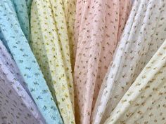 many different colors of fabric with small flowers on them