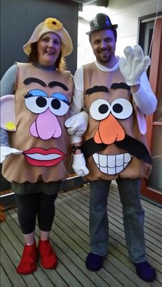 two people dressed in costumes standing on a deck