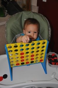 a baby sitting in a chair with a game on it's lap and the caption reads, more independent activities for one - year olds