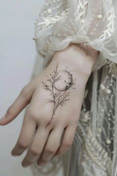 a woman's hand with a small tattoo on the wrist and flowers in it