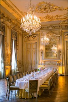 an elegant dining room with chandelier and tables