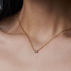 Modern and elegant, this 14k gold diamond necklace features an emerald cut diamond in a bezel setting on a paperclip chain from Gilded by G.St. Able to special order in rose or white gold- please allow 5 weeks for production and delivery. • 14k gold• 0.25ct emerald cut diamond (G-H color, SI clarity)• Chain length: 16-17" All G.St collections are designed and crafted by us in NYC using recycled gold, conflict-free diamonds and responsibly sourced gemstones. Diamond Necklace With Paperclip Chain As Gift, Diamond Necklace With Paperclip Chain For Gift, Emerald Cut Diamond, Gold Diamond Necklace, Emerald Cut Diamonds, Diamond Pendant Necklace, Recycled Gold, Conflict Free Diamonds, Bezel Setting