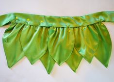 a close up of a green ribbon on a wall