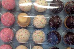 a display case filled with lots of different types of donuts and muffins