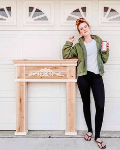 a woman standing next to a wooden table