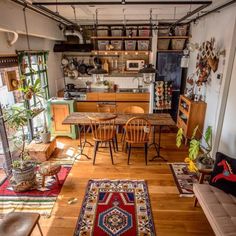 a living room filled with lots of furniture next to a kitchen and dining room table