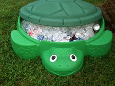 a green turtle shaped trash can with plastic bottles in it's shell and eyes