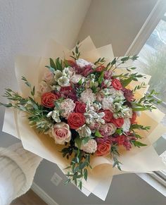 a bouquet of flowers sitting on top of a window sill