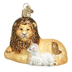 a glass ornament with a lion and lamb on it's back, sitting next to each other