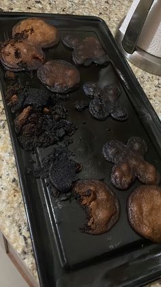 chocolate muffins are on a baking sheet in the middle of a counter top