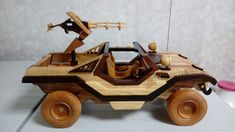 a wooden toy car with wheels and steerings