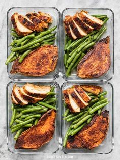 four glass containers filled with chicken, green beans and potatoes on top of a marble counter