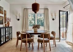 a dining room table with four chairs around it