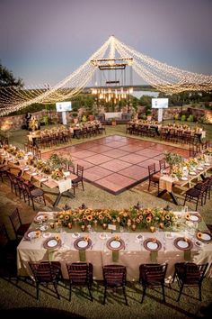 an overhead view of a tennis court with tables and chairs set up for a formal dinner