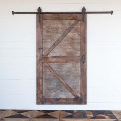 an old wooden door is hanging on the wall