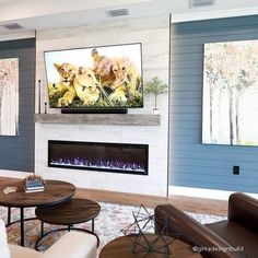 a living room with two couches and a television mounted on the wall above it