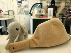 an elephant stuffed animal sitting on top of a counter