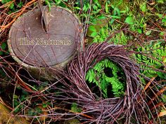 the naturals sign is surrounded by green plants and vines on the ground in front of a tree stump