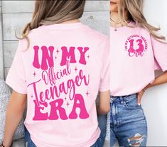 a woman wearing a pink shirt that says in my official teenager era