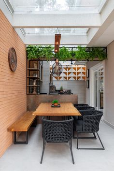 an indoor dining area with wooden table and black chairs