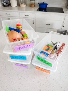 two plastic containers filled with food on top of a kitchen counter