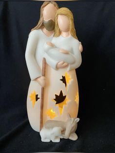 a ceramic figurine of two people holding each other with stars on the body