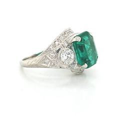 Gorgeous Vintage Diamond & Emerald in Platinum ring circ 1920's center set natural Colombia emerald weight 4.43ct size 11.1x9.3mm GIA cert. Has a nice rich green color ,brilliant clean very lively stones. Side Set two Natural old mine cut Diamonds Weight 0.50ct. Size 4mm SI1 -G lively brilliant, clean white bright stones. Side set small diamonds weight 0.25ct. Ring size 7.5 Resizable This tremendous old vintage ring is in a very good condition. Retail value $18,500 net. Appraisal available Vintage Green Diamond Platinum Ring, Vintage Green Diamond Ring In Platinum, Gia Certified Oval Emerald Ring In Art Deco Style, Gia Certified Art Deco Emerald Ring, Vintage Emerald Ring With Vvs Clarity, Art Deco Emerald Ring With Center Stone, Art Deco Emerald And Diamond Ring For May Birthstone, Vintage Platinum Emerald-cut Emerald Ring, Art Deco Round Cut Emerald Ring