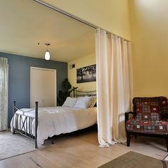 a bed sitting next to a window in a bedroom