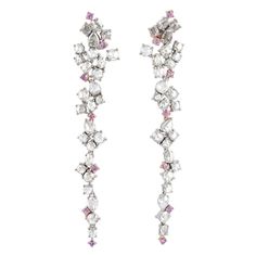 Handcrafted from 18-karat white gold, these exquisite drop earrings are set with 4.16 carats of rosecut diamonds and .6 carats pink sapphire. FOLLOW MEGHNA JEWELS storefront to view the latest collection & exclusive pieces. Meghna Jewels is proudly rated as a Top Seller on 1stDibs with 5 star customer reviews. All items manufactured by us are handmade and can be customized or redesigned. Composition Size-71X13 MM Total Weight-12 Gold Weight(Gms)-11.048 Diamond Wt(Cts)-4.16 Pink Sapphire Wt(Cts)-0.6 Formal White Cluster Earrings With Single Cut Diamonds, Luxury Bridal Rose Cut Diamond Drop Earrings, Luxury Rose Cut Drop Diamond Earrings, White Diamond Earrings With Sparkling Stones, Luxury White Cluster Earrings With Single Cut Diamonds, Luxury White Gold Bridal Earrings With Rose Cut Diamonds, Formal White Bridal Earrings With Rose Cut Diamonds, Luxury White Diamond Linear Earrings, White Diamond Earrings With Sparkling Stones For Evening