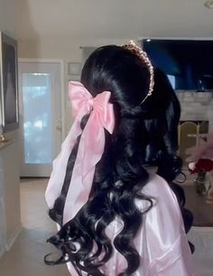 a woman with long black hair wearing a pink dress and a bow in her hair