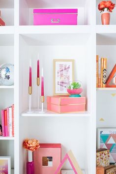 the shelves are filled with pink and gold items