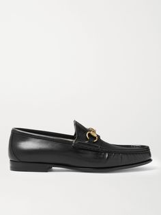 Gucci's iconic loafers were first introduced in 1953; it says a lot about the timelessness of the design that they've barely changed since. This glossy black version has been crafted in Italy from leather embellished with the hallmark horsebit that nods to the brand's equestrian heritage. Leather Business Shoes With Horsebit Detail, Leather Horsebit Business Shoes, Leather Horsebit Shoes For Business, Business Leather Shoes With Horsebit Detail, Gucci Leather Shoes With Calf Leather Sole, Gucci Calf Leather Shoes With Leather Sole, Gucci Luxury Calf Leather Loafers, Gucci Luxury Loafers With Leather Lining, Luxury Gucci Calf Leather Loafers