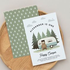 a card with an image of a camper and a bear in the woods on it