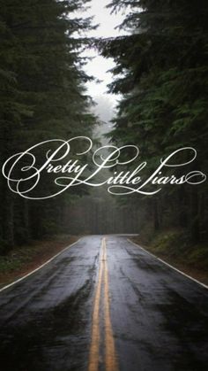 an empty road surrounded by trees with the words pretty little house written in white on it