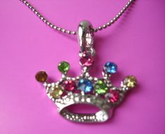 "crown pendant necklace. Vintage. Colourful glass rhinestones with silver-plated metal chain. Crown approx. 1 \" x  2,5 cm Necklace approx. 15,5 \" / 40 cm long" Multicolor Jeweled Rhinestone Necklace For Gift, Multicolor Jeweled Rhinestone Necklace Gift, Crown Shaped Rhinestone Jewelry For Gifts, Chain Crown, 2000s Accessories, 2000s Jewelry, Crown Pendant Necklace, Crown Pendant, Y2k Necklace