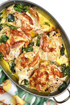 a pan filled with chicken and spinach covered in cheese