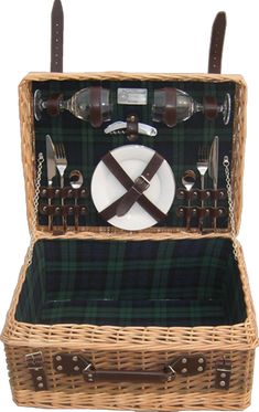 a picnic basket with utensils and plates in it