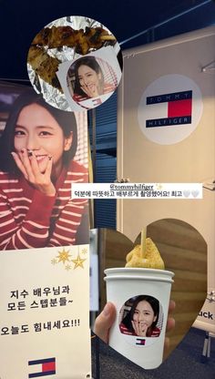 a woman holding up a cup of ice cream in front of a sign with pictures on it