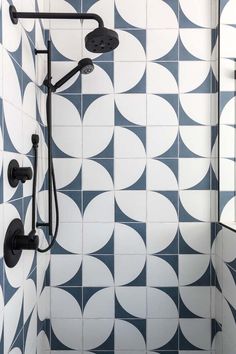 the shower head and hand shower are connected to the wall in this modern tiled bathroom