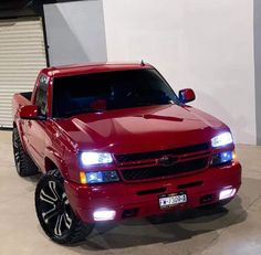 a red truck is parked in a garage