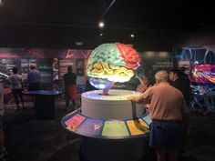 people standing around looking at an interactive brain model