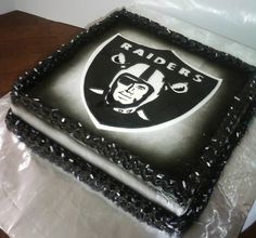 a black and white oakland football logo cake