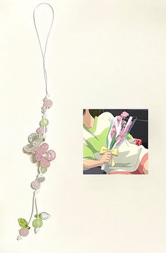 an image of a woman holding flowers in her hand and hanging from a string on the wall