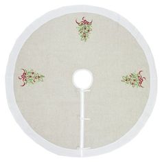 a white round table with holly decorations on it