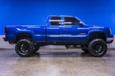 a large blue truck parked in a garage