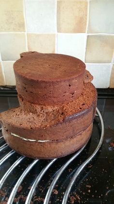 three chocolate cakes stacked on top of each other