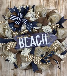 a wreath made out of burlocks with the word beach on it and some ribbons