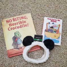 there are two children's books on the floor and one has a hair band