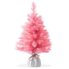 a pink christmas tree in a white ceramic pot